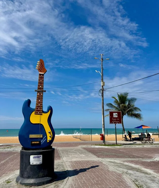 Escultura de guitarra azul e amarela na orla da praia de Costazul, Rio das Ostras